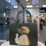 green tote bag with artistic print